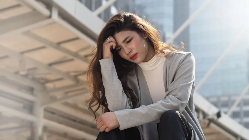 A woman sitting and crying.