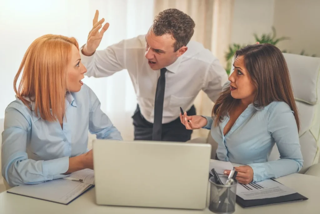 A boss angrily shouting at their employees.