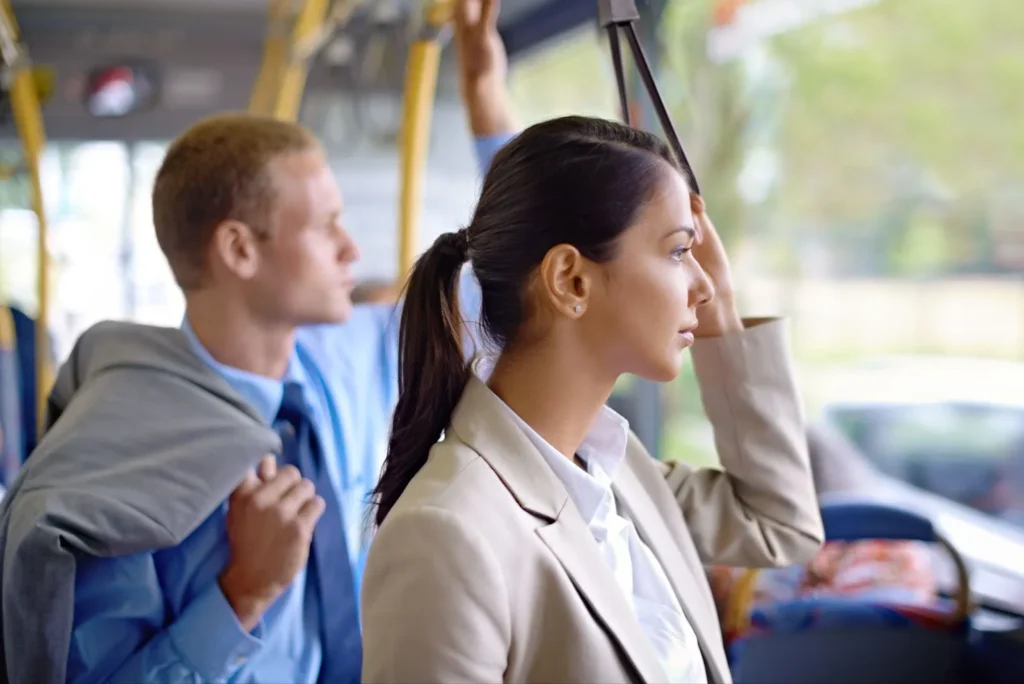 A Latina woman standing in the bus