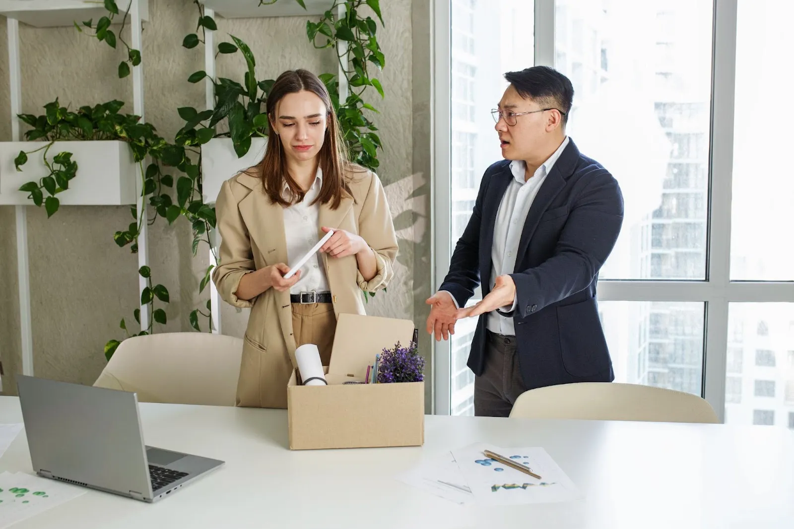 A woman collecting her belongings while a man complains at her.
