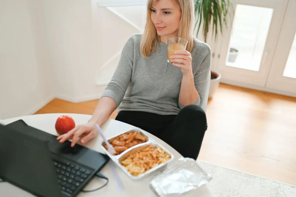 A woman eating at the workplace