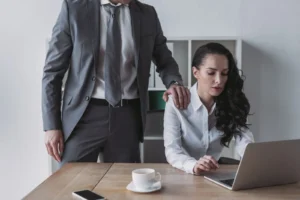 A man placing his hand on a woman’s shoulder