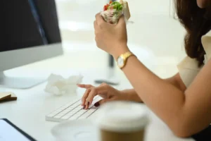 A woman eating at the workplace